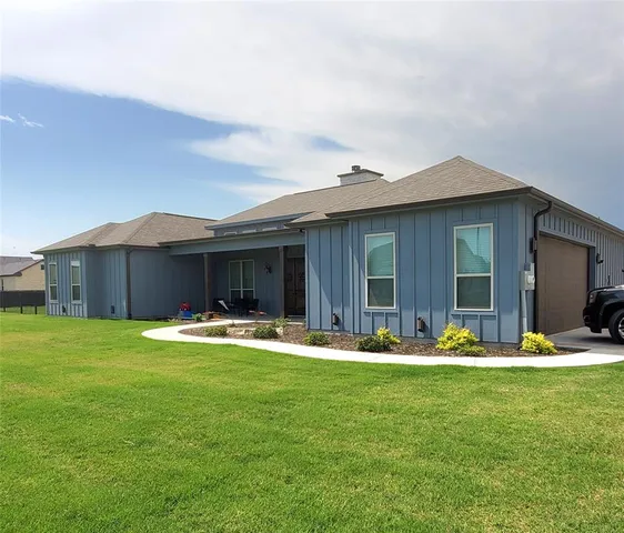 a backyard of a house with yard table and chairs