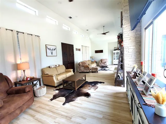 a living room with furniture window and wooden floor