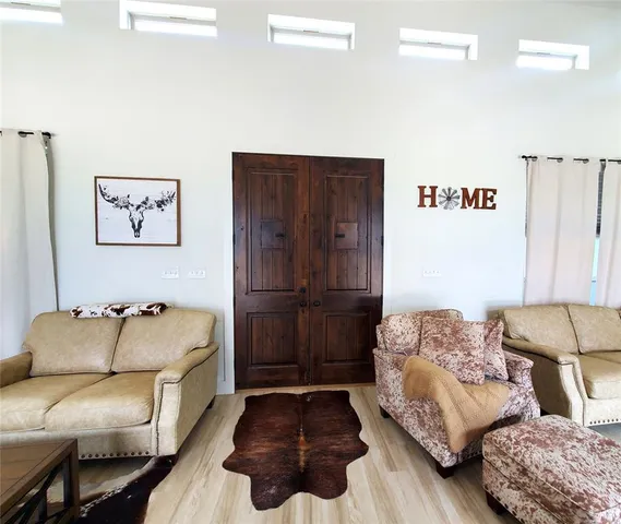 a bedroom with furniture and wooden floor