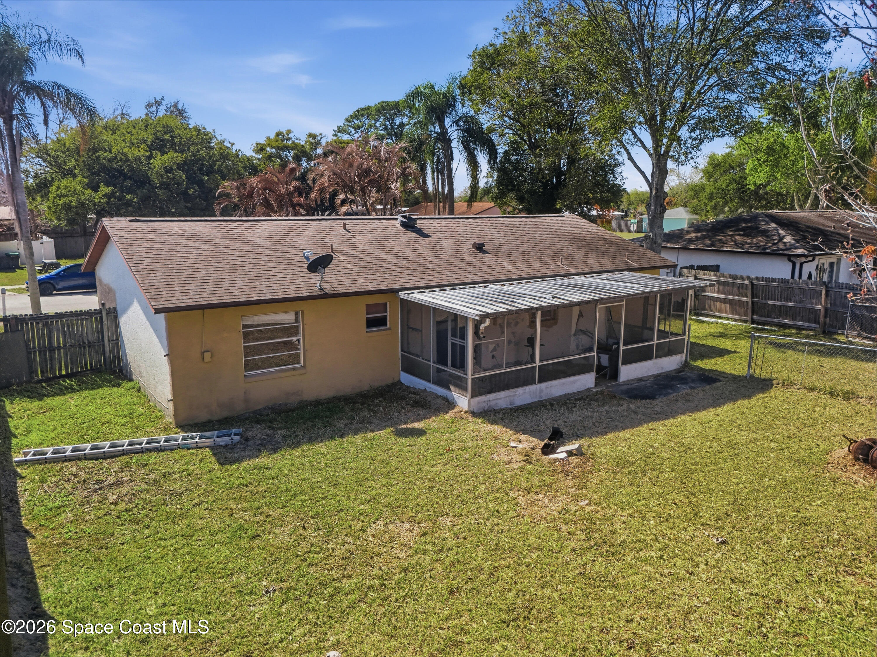 3660 Longbow Road Cocoa, FL 32926 - Photo 5 of 13 a aerial view of a house with swimming pool next to a yard