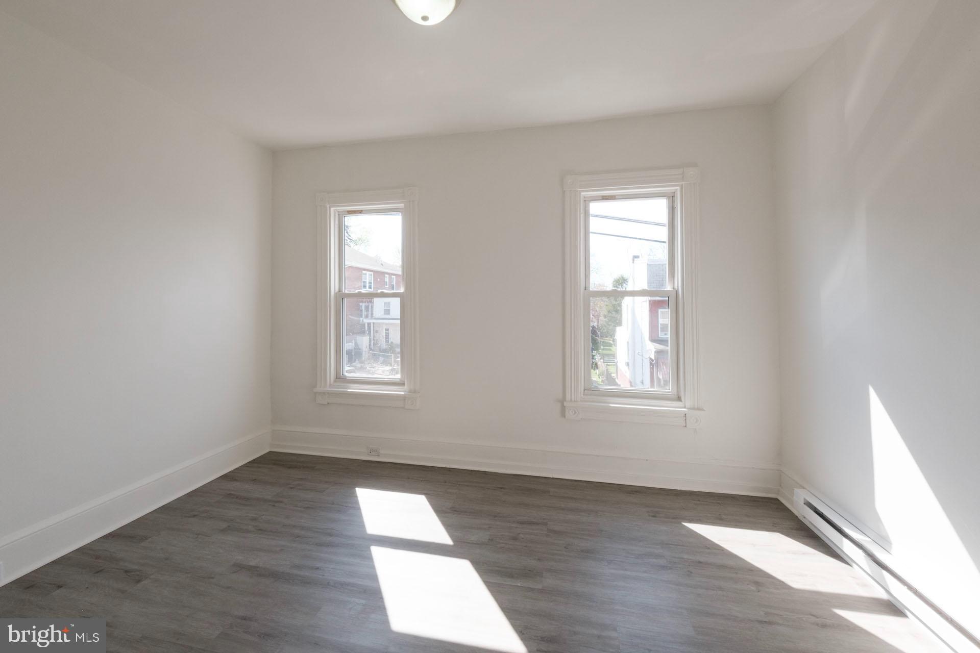 525 South 18th Street Reading, PA 19606 - Photo 13 of 18 an empty room with wooden floor and windows