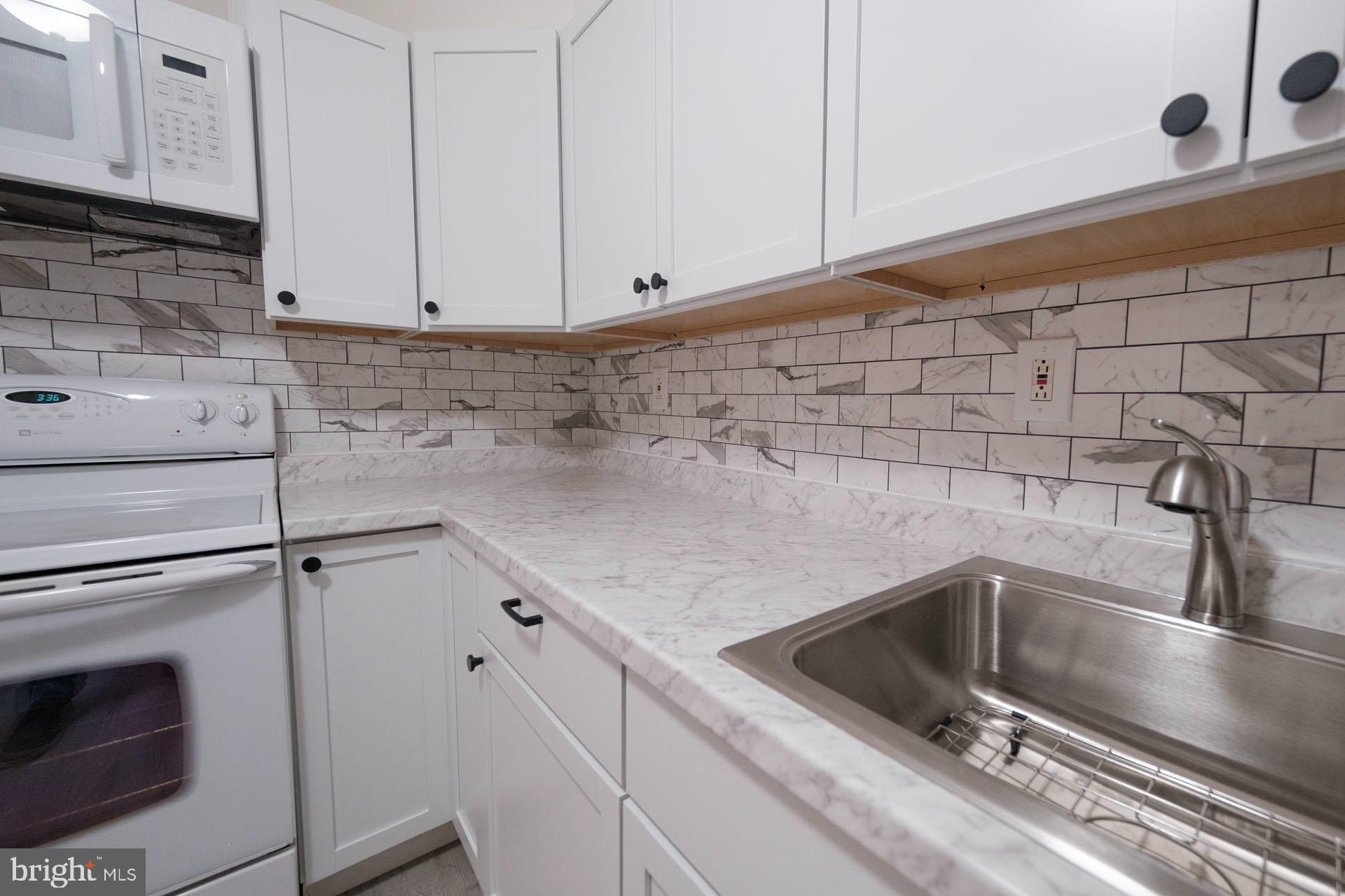 525 South 18th Street Reading, PA 19606 - Photo 7 of 18 a close view of a sink dishwasher and stove