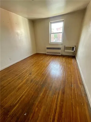 an empty room with wooden floor