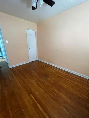 a view of a room with wooden floor