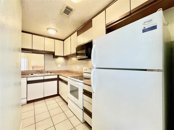 a kitchen with stainless steel appliances a refrigerator sink and cabinets
