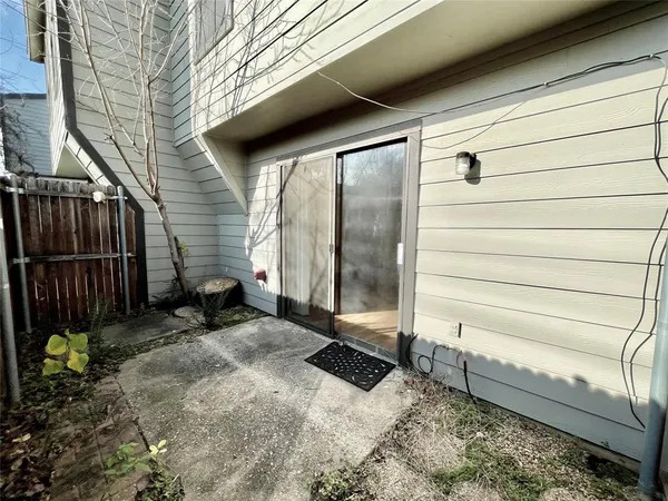 a view of a house with a wooden fence