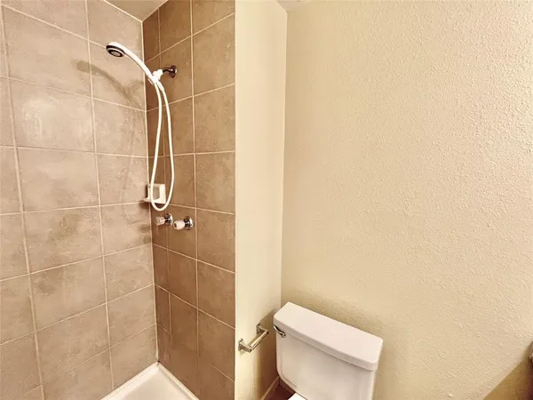 a bathroom with a toilet and a shower