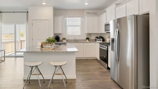 a kitchen with stainless steel appliances a refrigerator sink and cabinets