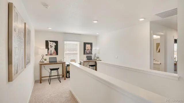 a kitchen with a sink and chairs