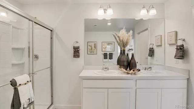 a bathroom with a sink vanity and mirror