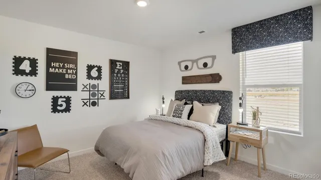 a bedroom with a bed and a chair