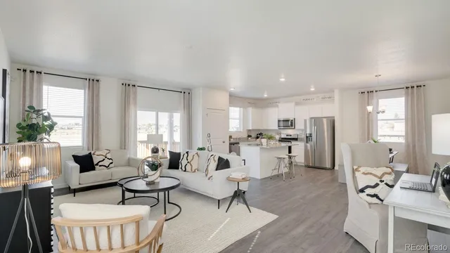 a living room with furniture dining table and a large window