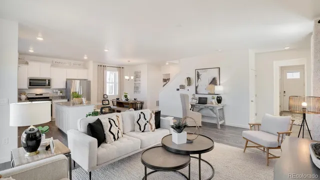 a living room with furniture and kitchen view