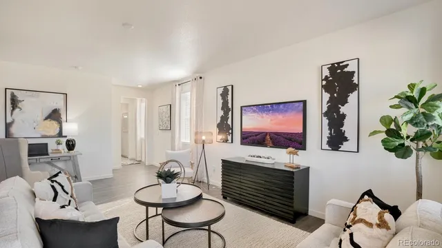 a living room with furniture a potted plant and a fireplace