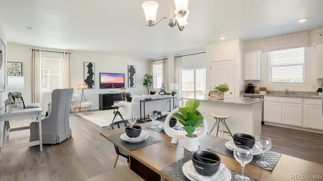 a kitchen with stainless steel appliances a dining table and chairs