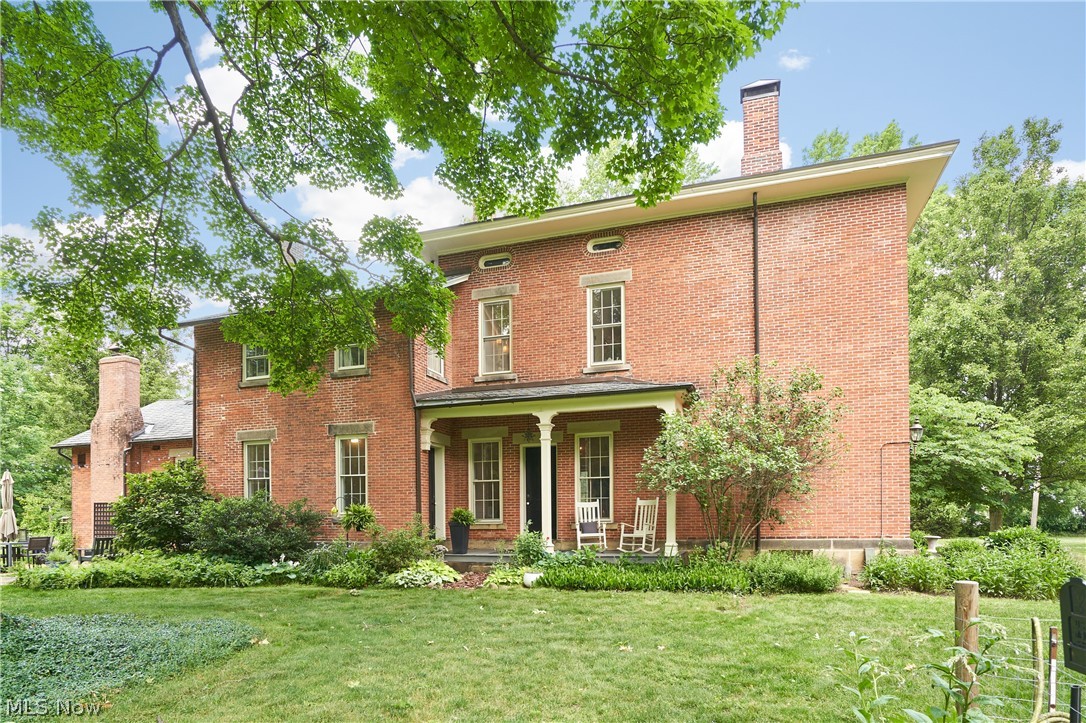 5046 Alger Road Richfield, OH 44286 - Photo 6 of 49 Classic brick exterior featuring multiple windows and a covered front porch