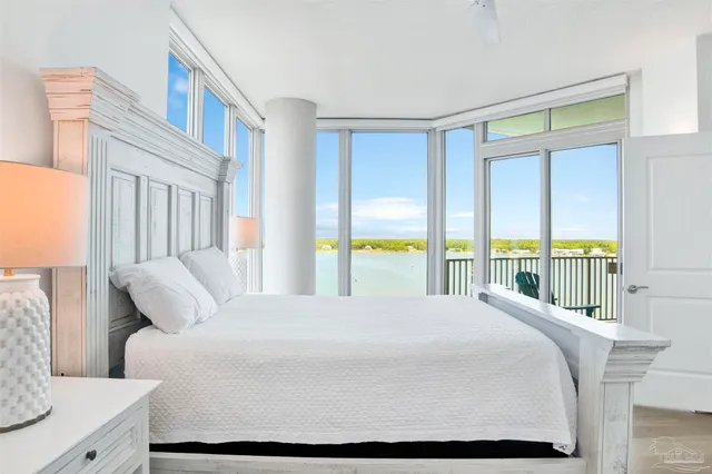 a bedroom with a large bed and a window