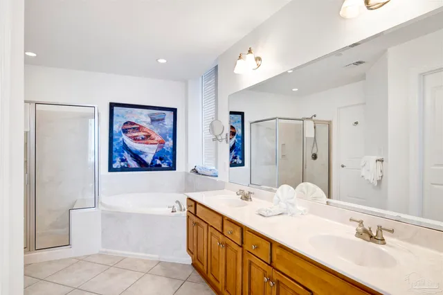 a spacious bathroom with a double vanity sink mirror and bathtub
