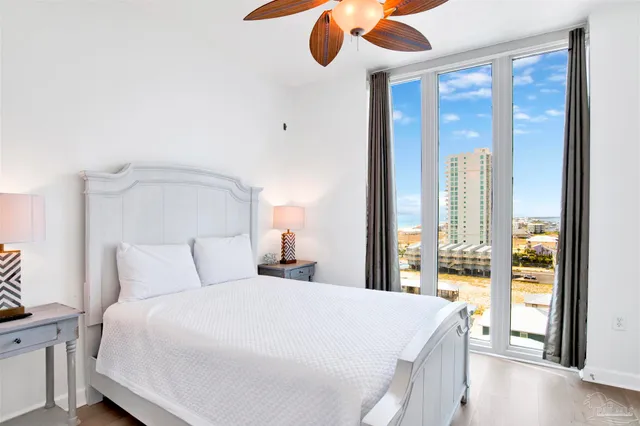 a bedroom with a large bed and a large window