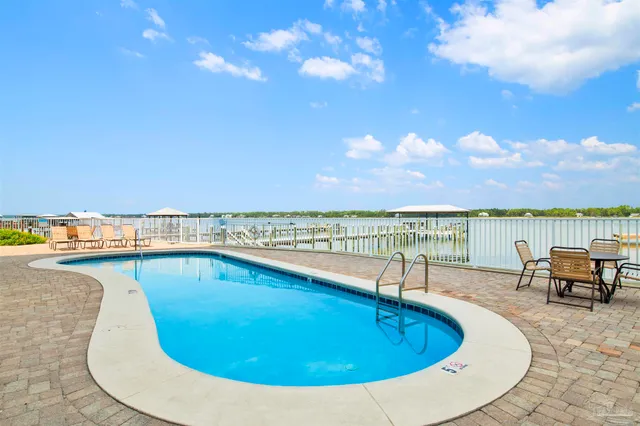 a view of swimming pool with outdoor seating and city view