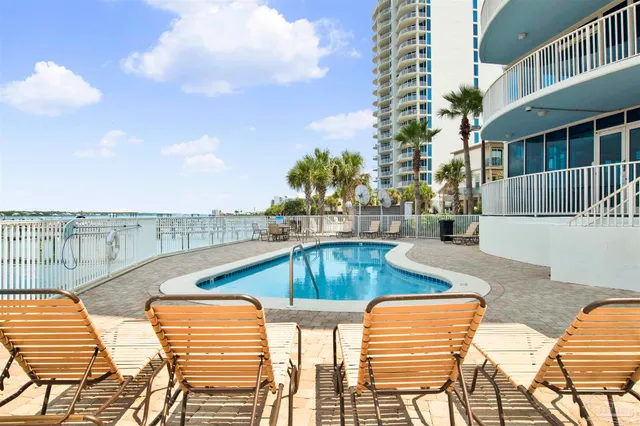 a view of a swimming pool with a table and chairs