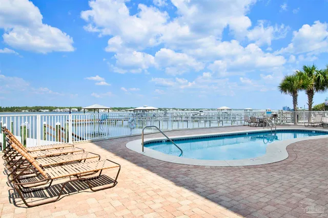 a view of a patio with swimming pool table and chairs