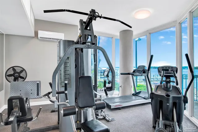 a front view of multi story residential apartment building with yard and sign board