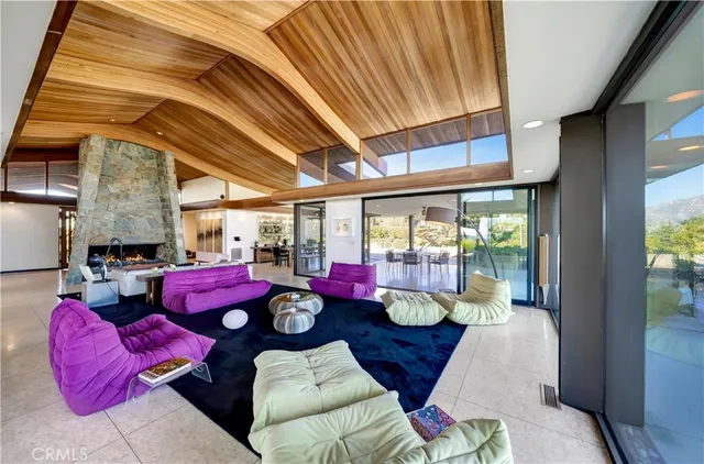 a living room with furniture and a floor to ceiling window