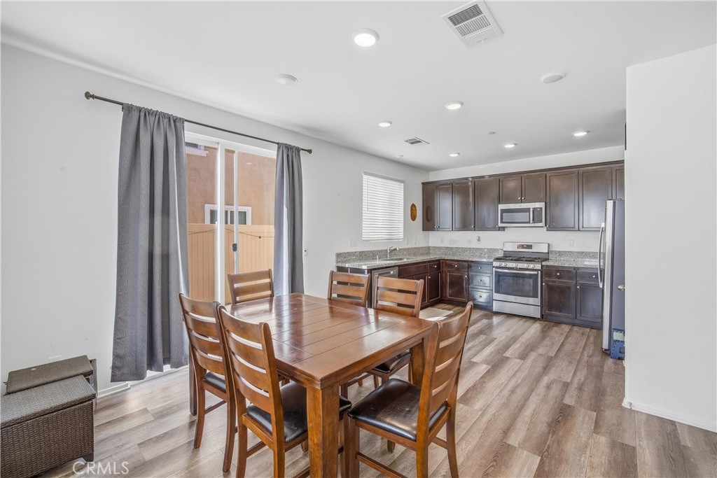 925 Bluebell Way Beaumont, CA 92223 - Photo 12 of 33 a kitchen with a table and chairs in it