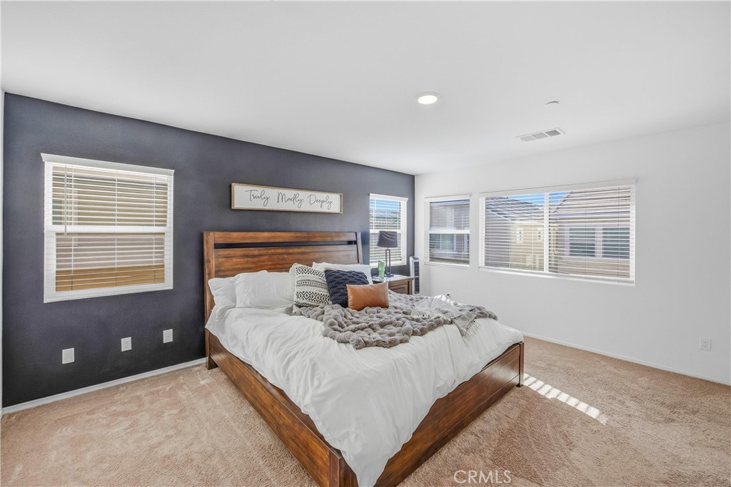 925 Bluebell Way Beaumont, CA 92223 - Photo 17 of 33 a bedroom with a large bed and a window