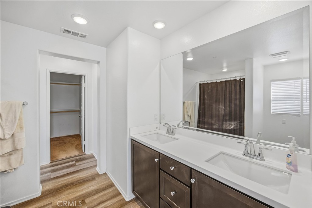 925 Bluebell Way Beaumont, CA 92223 - Photo 21 of 33 a bathroom with a double vanity sink and a mirror
