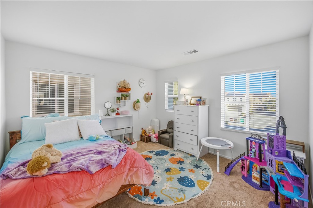 925 Bluebell Way Beaumont, CA 92223 - Photo 26 of 33 a bedroom with a bed and window