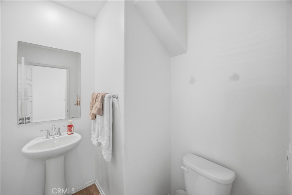 925 Bluebell Way Beaumont, CA 92223 - Photo 6 of 33 a bathroom with a toilet sink and mirror