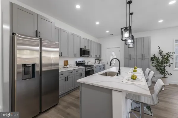 a kitchen with refrigerator and cabinets