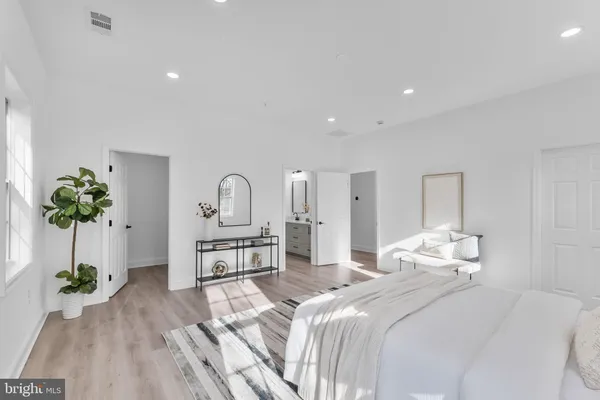 a bedroom with a bed and a potted plant