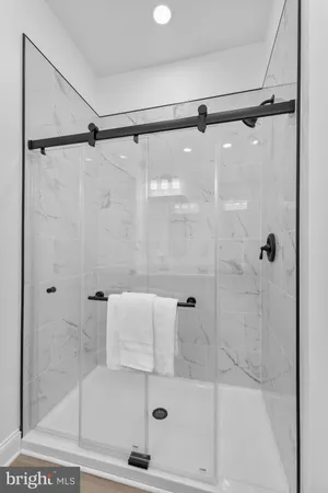 a bathroom with a shower and a glass door