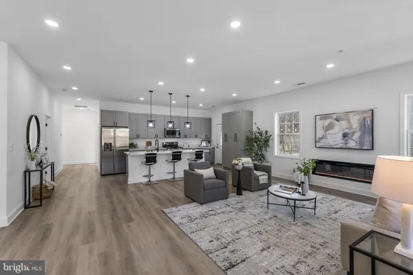 a living room with lots of furniture and kitchen view