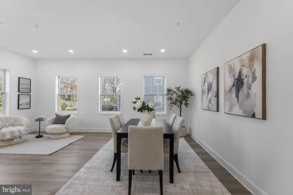 a view of a a dining room with furniture window and wooden floor