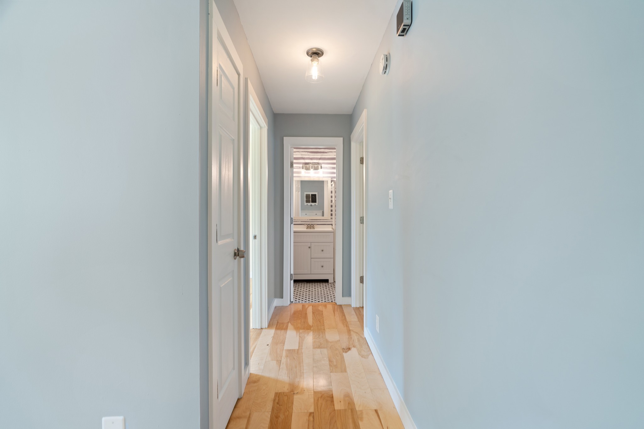 1327 Hugh Hunter Road Oak Grove, KY 42262 - Photo 24 of 36 a view of a hallway with wooden floor and a bathroom