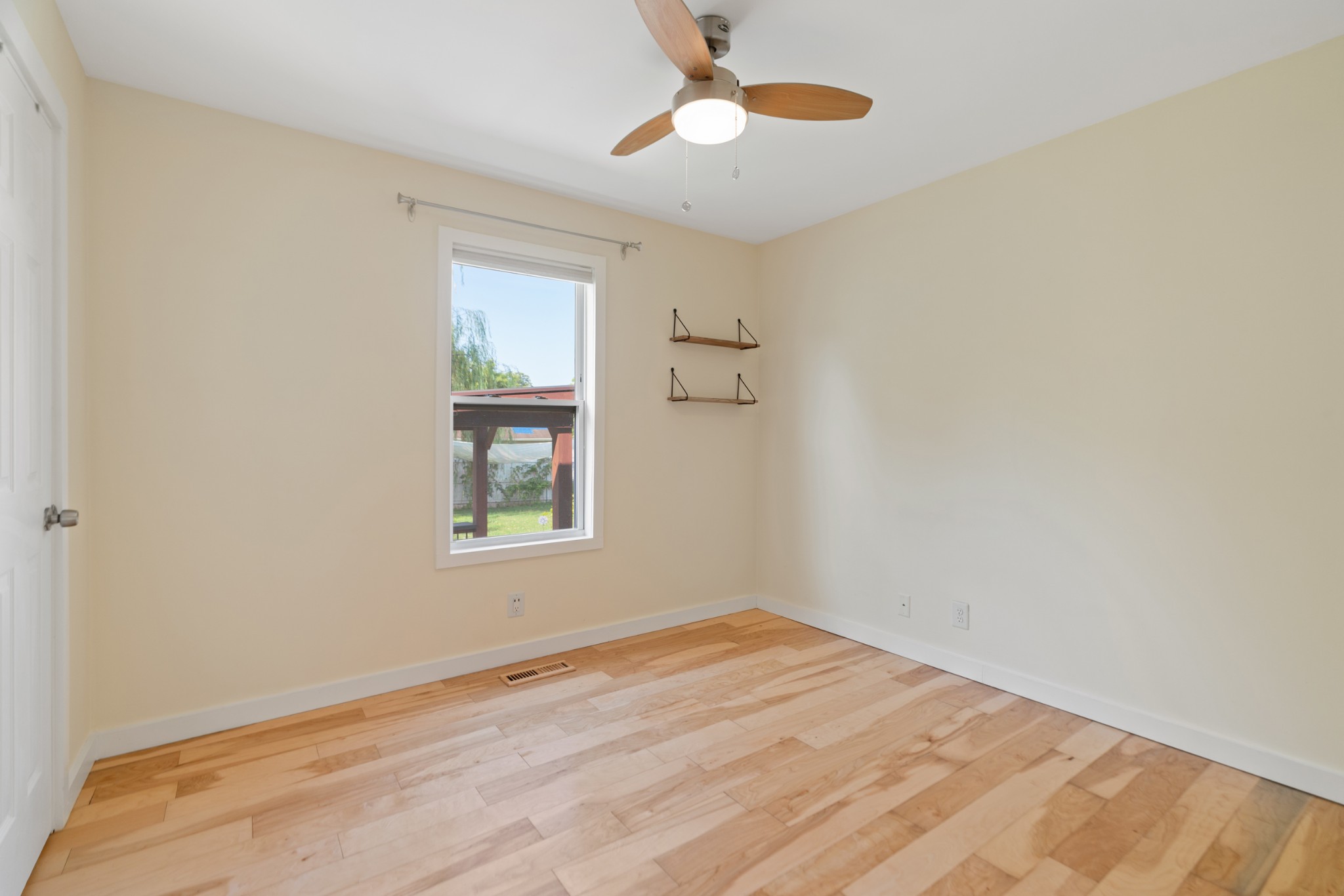 1327 Hugh Hunter Road Oak Grove, KY 42262 - Photo 27 of 36 a view of empty room with wooden floor and fan