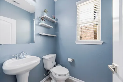 a bathroom with a sink a mirror and a toilet