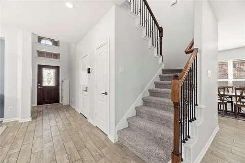 a view of entryway with wooden floor and stairs