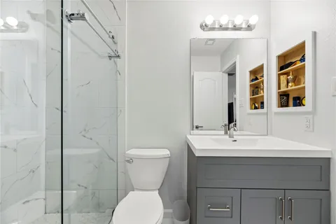 a bathroom with a sink toilet and shower
