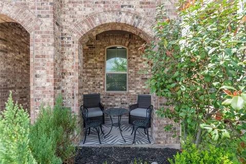 a front view of a house with table and chairs
