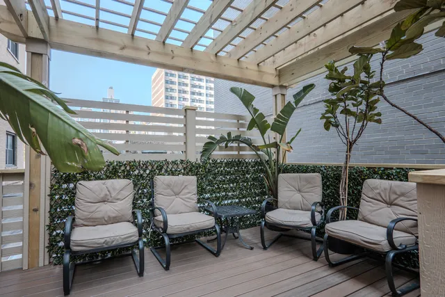 a view of a roof deck with table and chairs