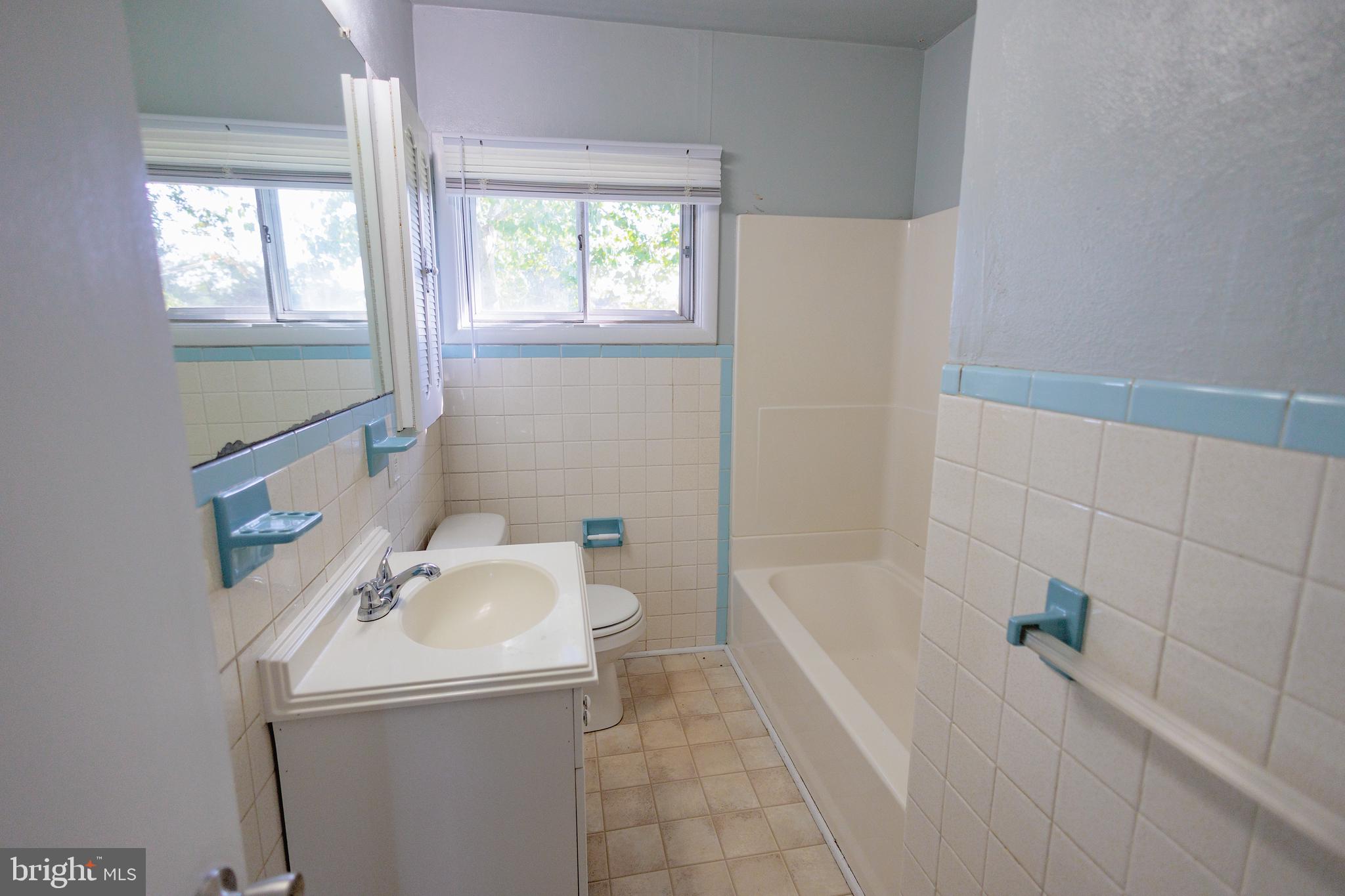200 Baldwin Road Glassboro, NJ 08028 - Photo 11 of 29 a bathroom with a sink a bathtub and window