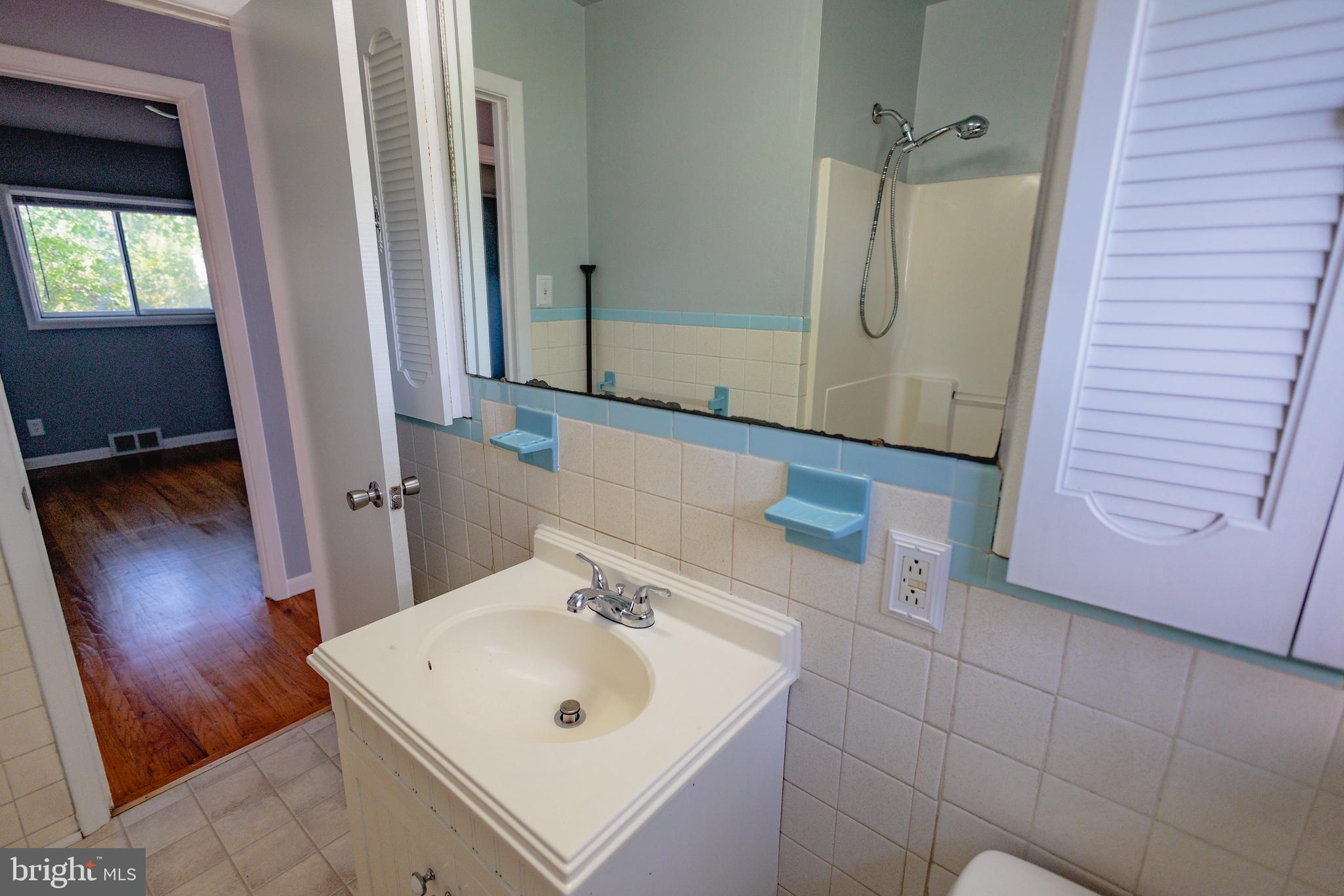 200 Baldwin Road Glassboro, NJ 08028 - Photo 13 of 29 a bathroom with a sink a toilet and mirror