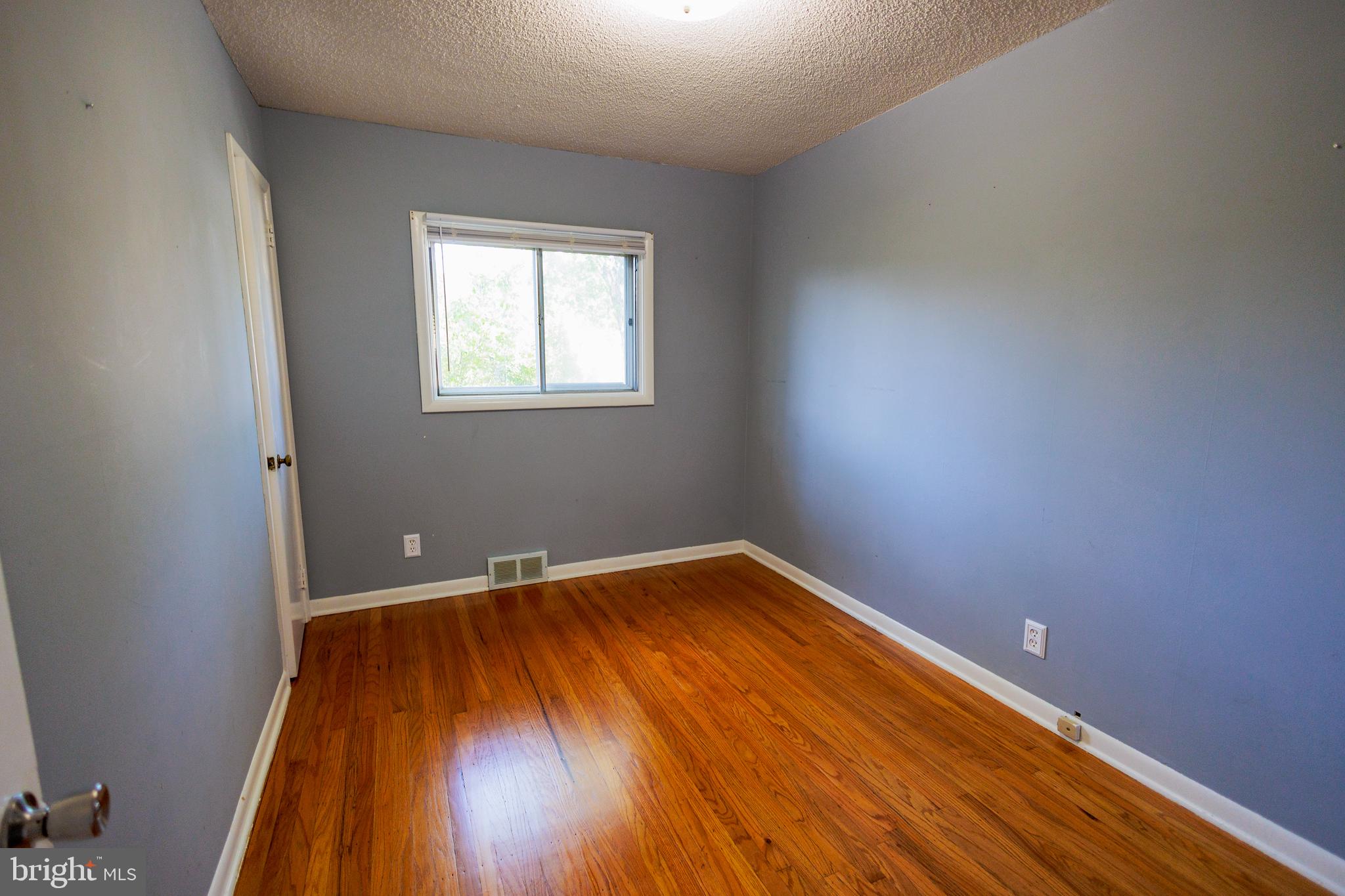 200 Baldwin Road Glassboro, NJ 08028 - Photo 15 of 29 a view of an empty room with wooden floor and a window