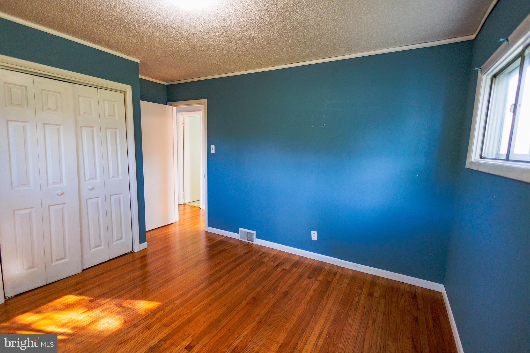 200 Baldwin Road Glassboro, NJ 08028 - Photo 20 of 29 an empty room with wooden floor and windows