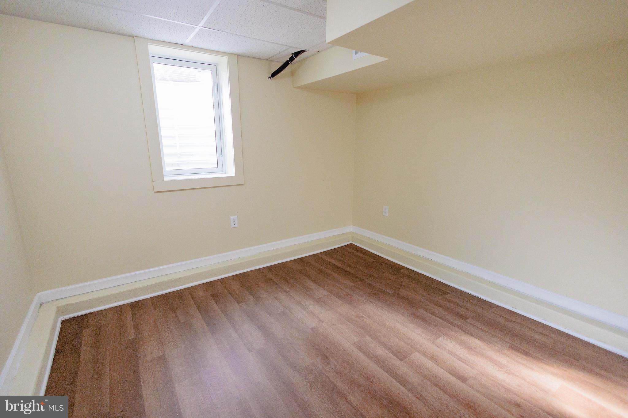 200 Baldwin Road Glassboro, NJ 08028 - Photo 26 of 29 a view of an empty room with wooden floor and a window